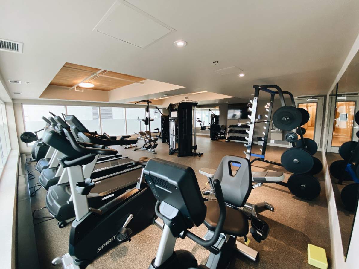 A well-equipped gym facility featuring treadmills, exercise bikes, and weights.